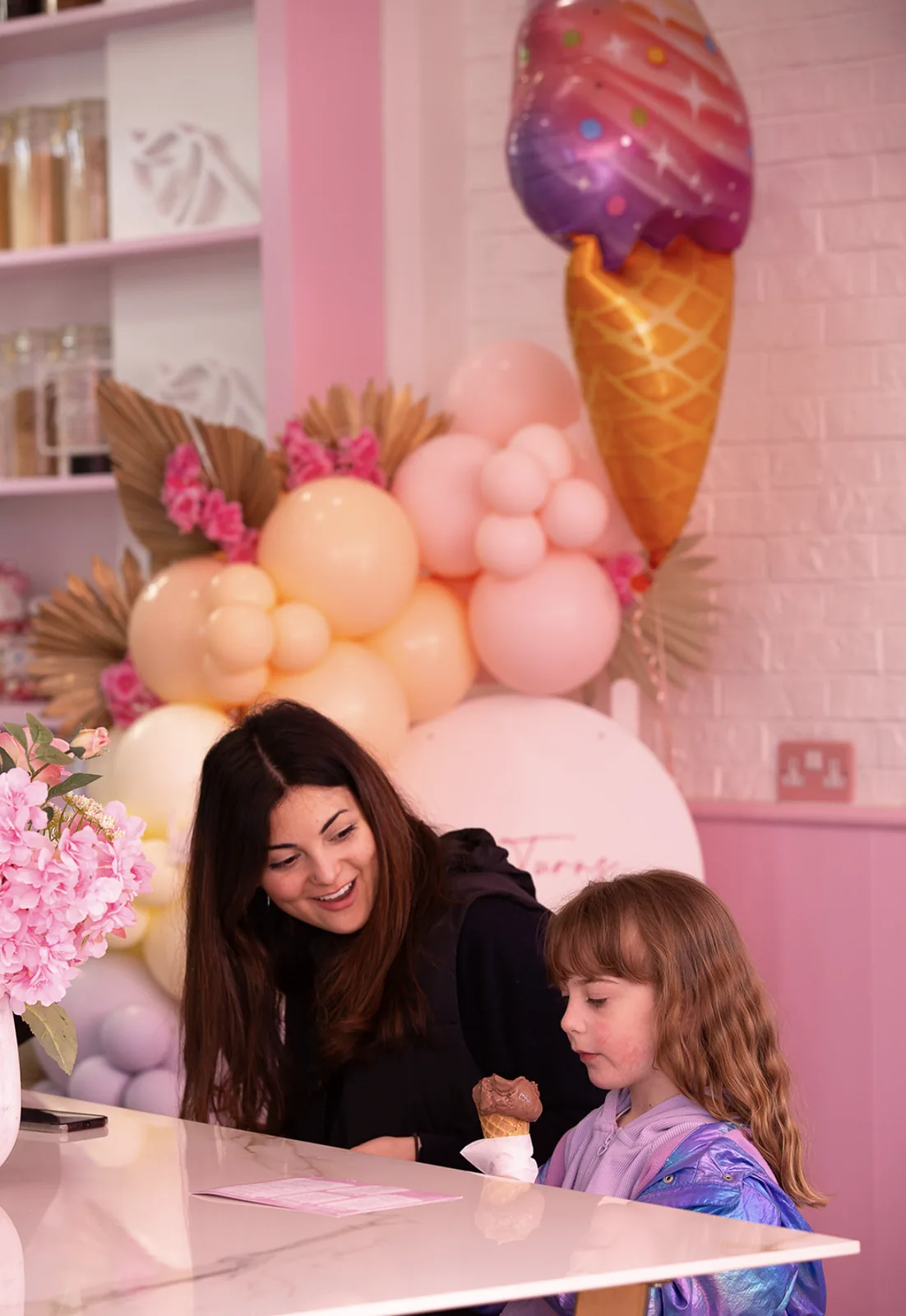 The parlour under a balloon arch, set up for a party