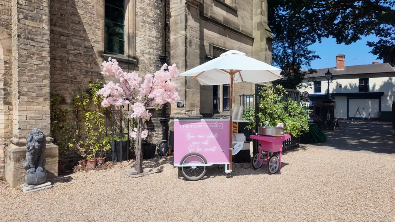 The pink gelato cart serving guests at a wedding