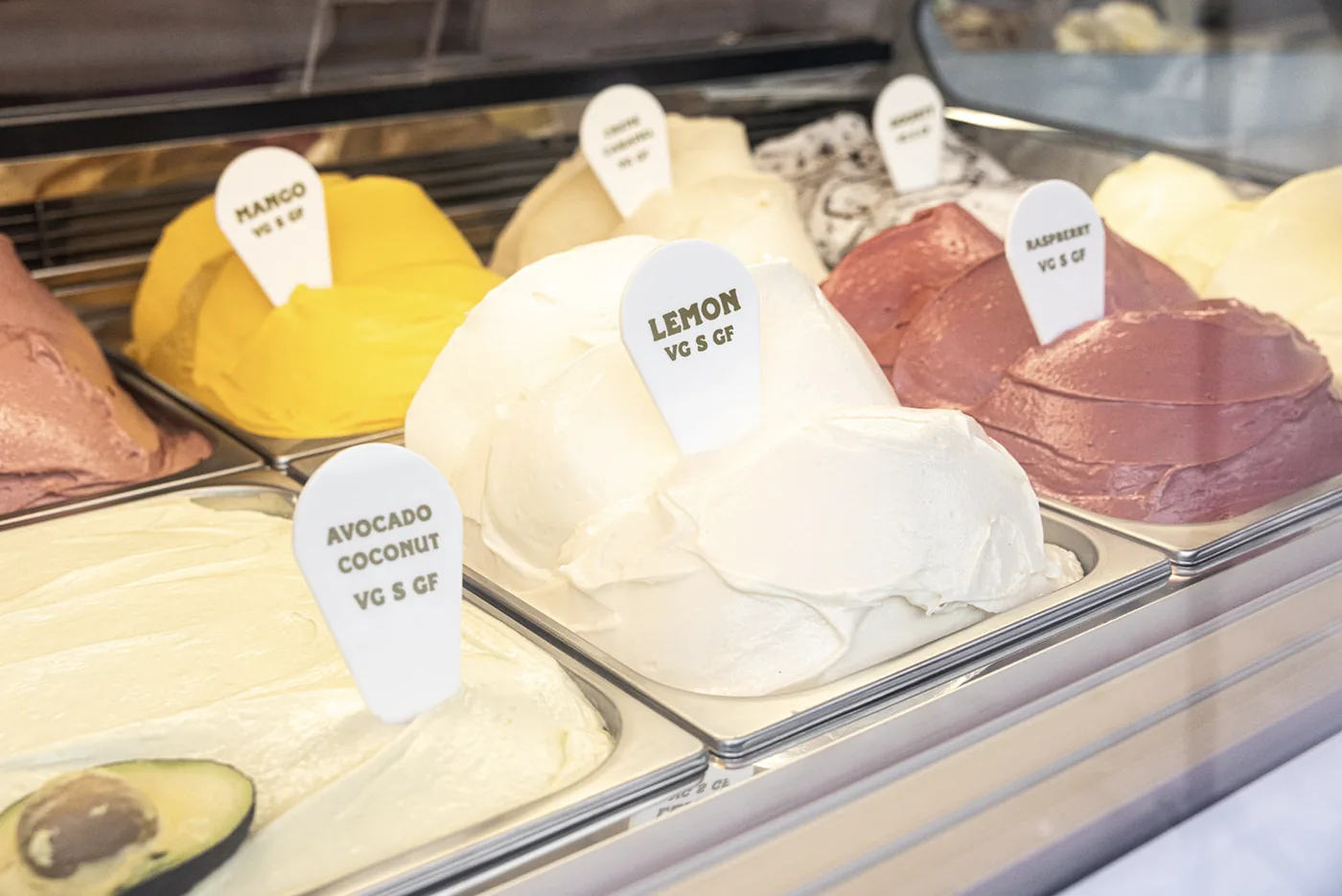 Pans of vegan gelato in the counter cabinet